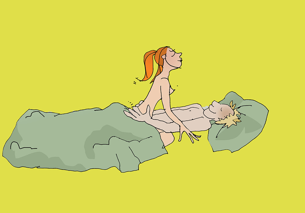 A woman and a man have sex in bed in riding position